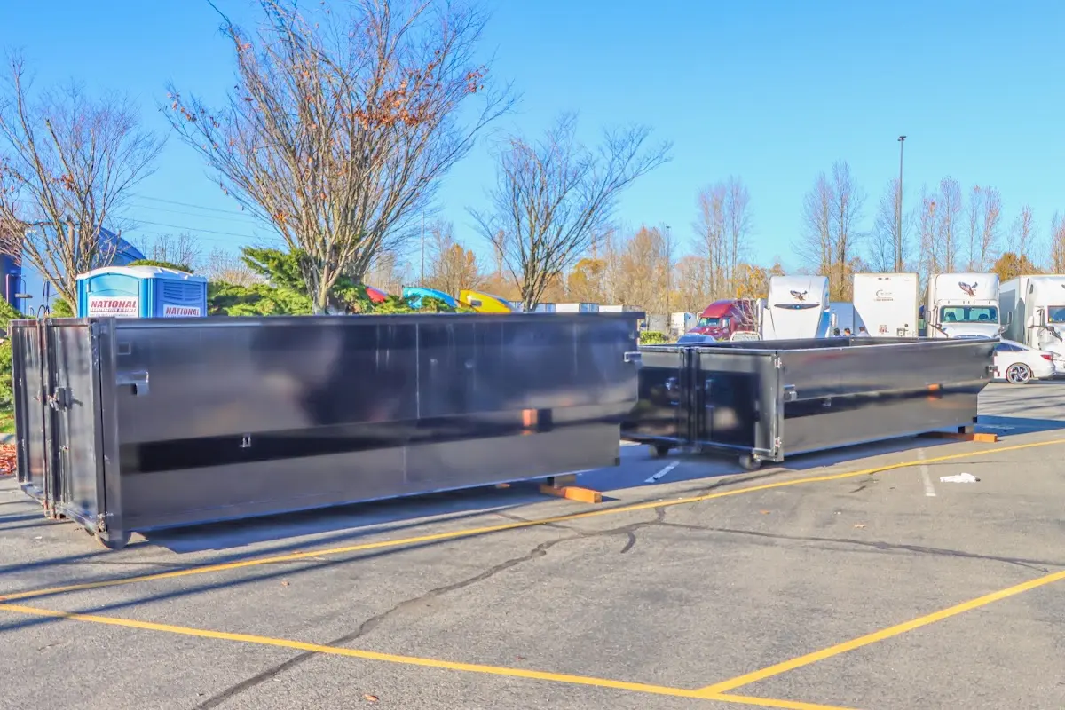 Professional dumpster rental service with roll-off container on residential driveway in Welby